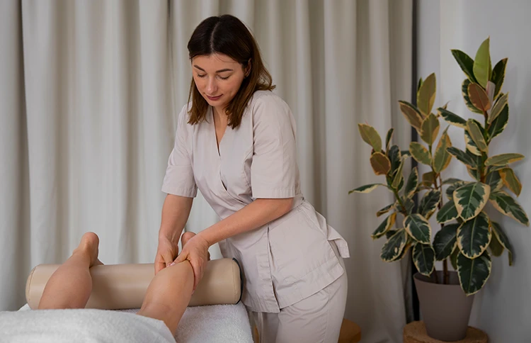 Therapist performing manual lymphatic drainage on the leg to support lipedema symptom management