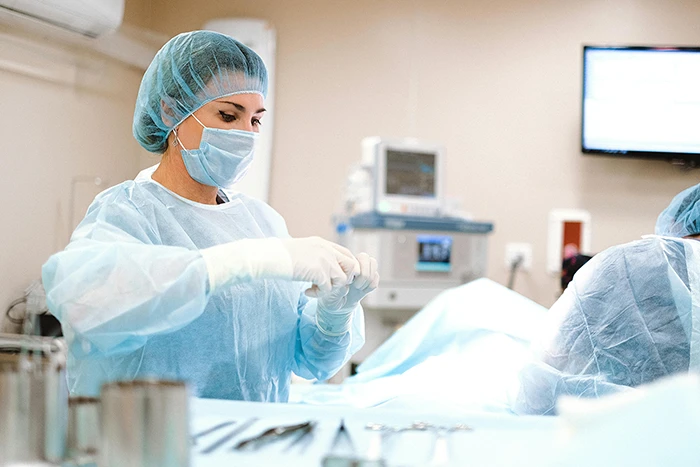 A cosmetic surgeon working on a client