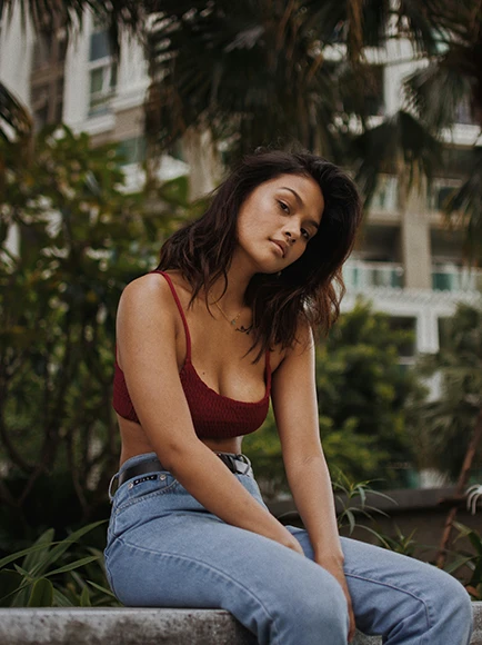 A woman in a red top and jeans