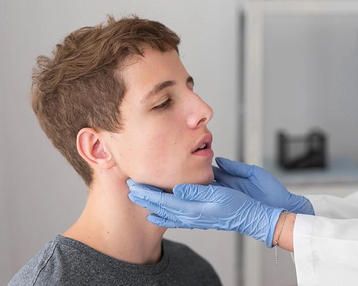 A picture of a boy getting inspected by a doctor