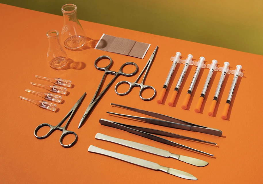 A set of cosmetic surgery tools arranged neatly on a sterile surface.