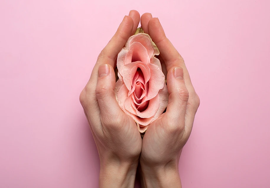 A picture of a woman holding a flower symbolizing taking care of her vagina