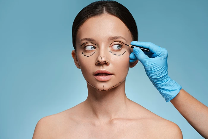 A woman getting her face marked up for surgery