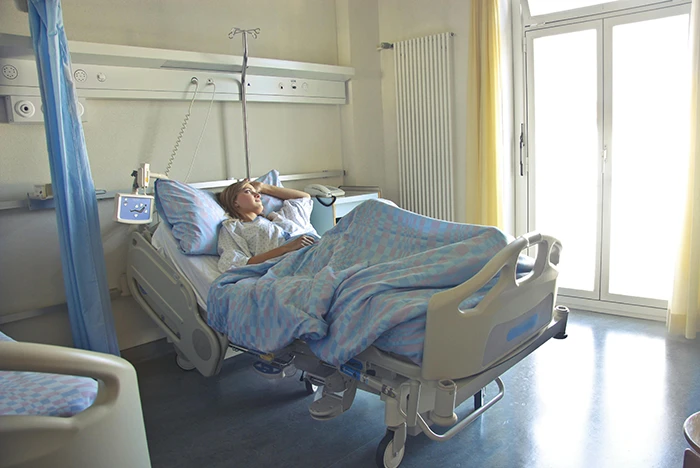 A female patient on a patient bed in a hospital 