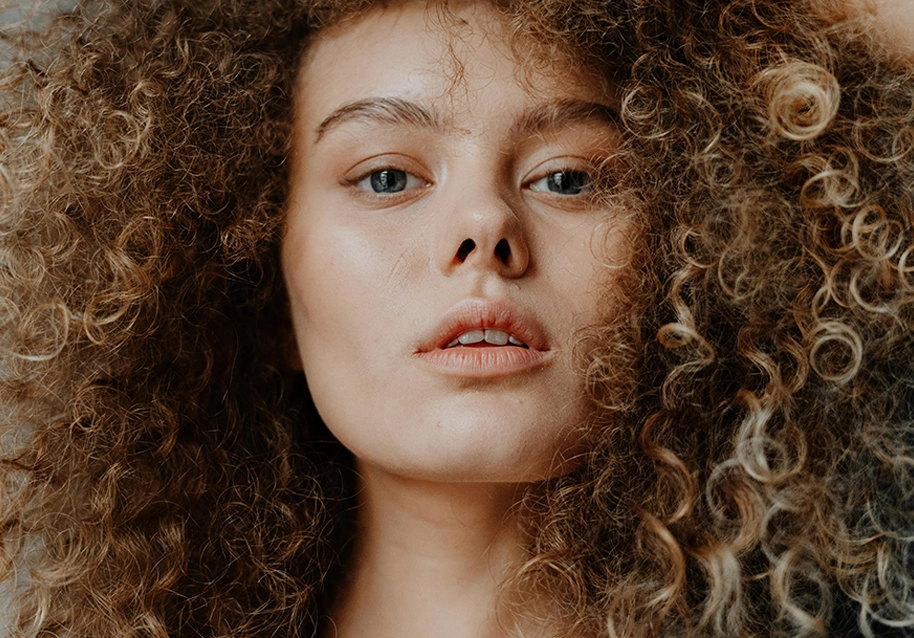 A person with brown curly hair