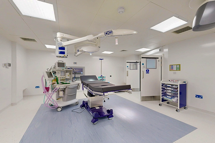 Modern operating theatre at London Private Hospital with adjustable surgical table, anaesthesia workstation, ceiling-mounted lights and sterile setup.
