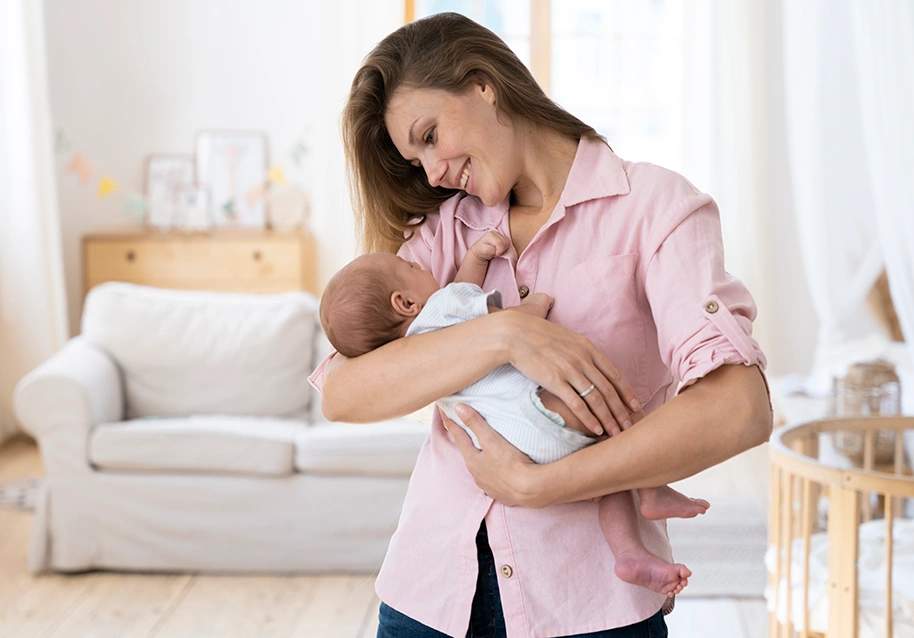 New mum bonding with her baby in a bright living room